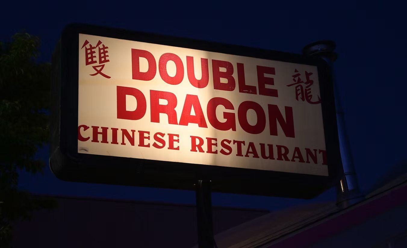 Double Dragon restaurant sign is lit up at night