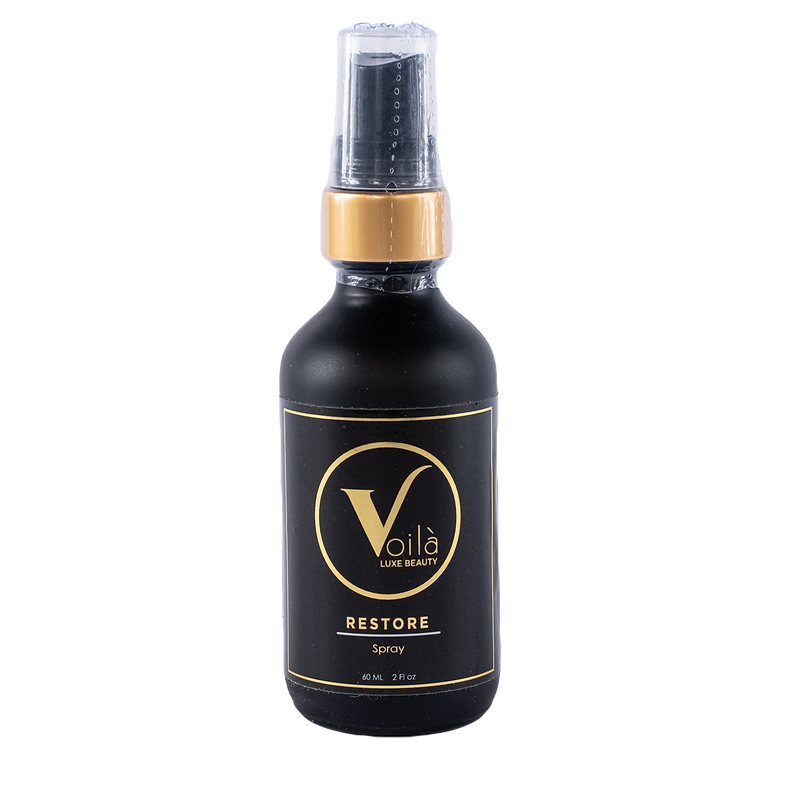 Black bottle with gold label and spray cap, labeled “V’lo Restore.”