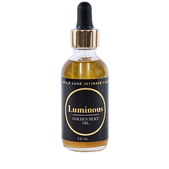 Small amber dropper bottle labeled “Luminous Golden Silk Oil” with black dropper cap.