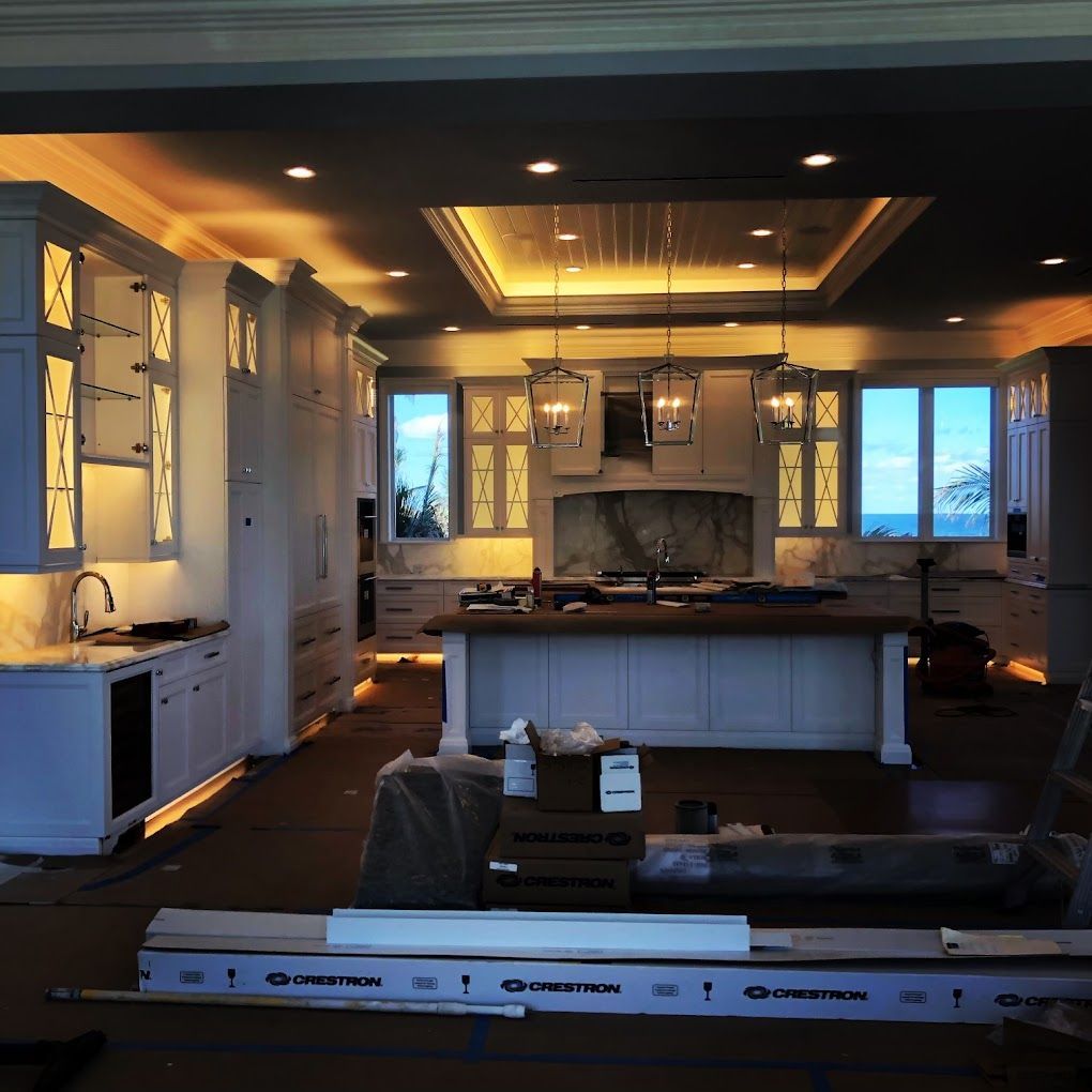 A kitchen with white cabinets and a large island
