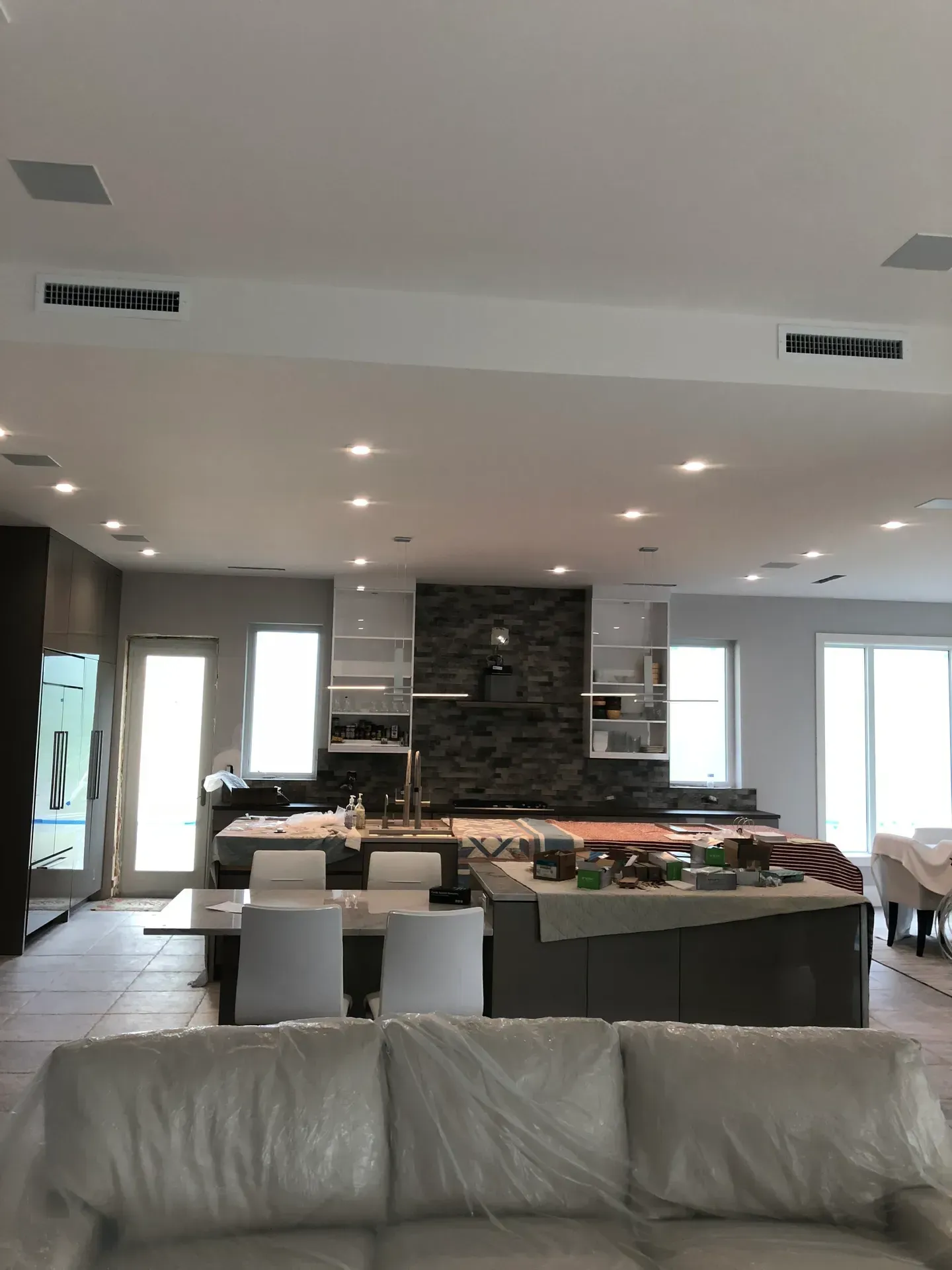 A living room with a couch and a kitchen in the background