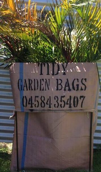 Sign for Tidy Garden Bags on a tan sack with green plants behind it. — Bad Bugs Pest Control in Rockhampton, QLD