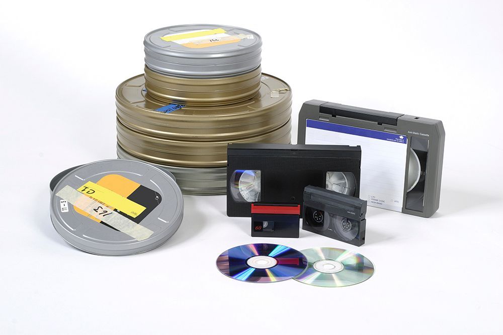 A group of video tapes and cds are stacked on top of each other
