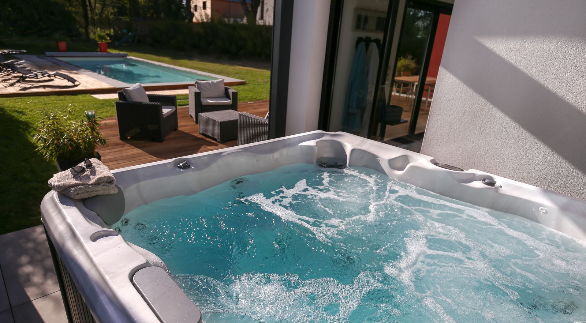 A large swimming pool is being built in a backyard.