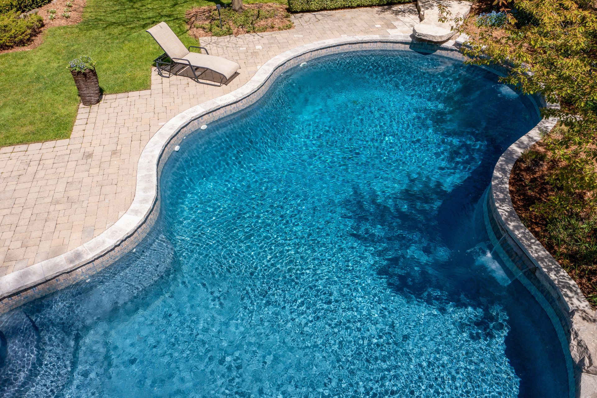 A large swimming pool is being built in a backyard.