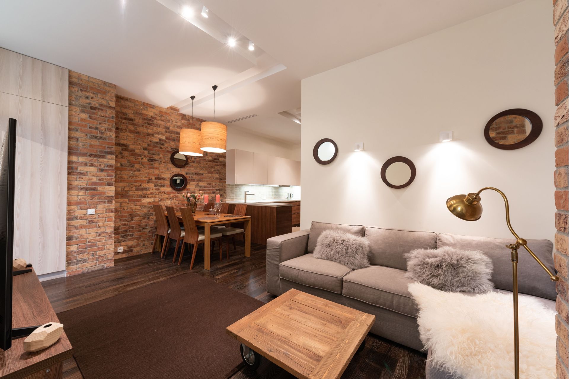 A living room with a couch , table and television.