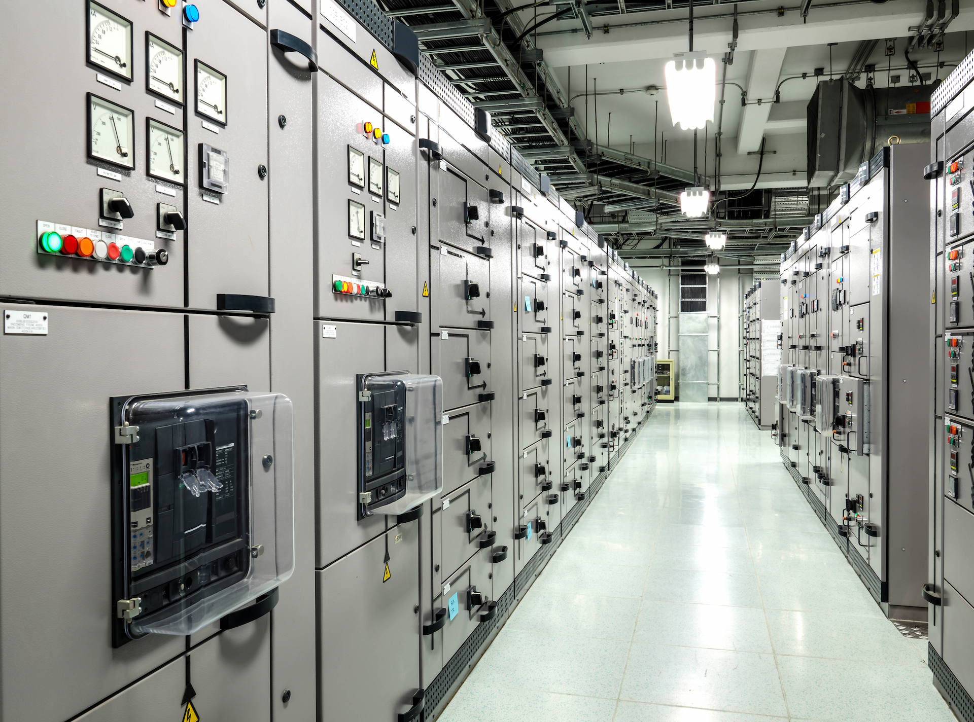 A long hallway filled with lots of electrical panels.