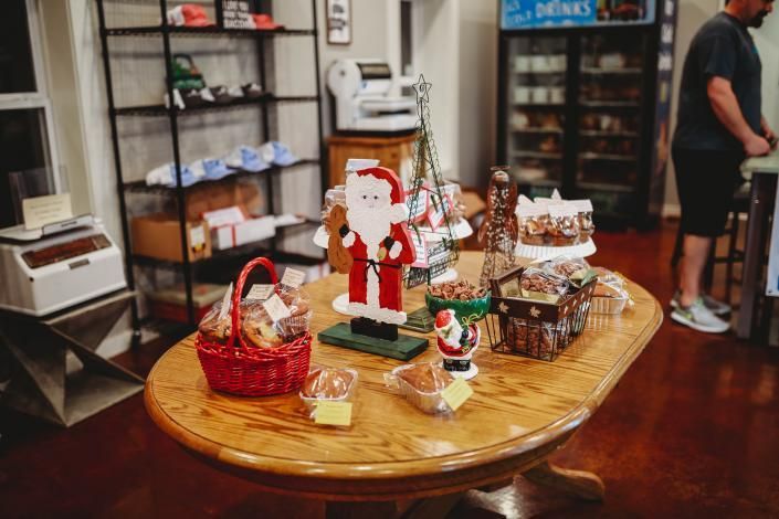 Holiday display table with Santa and seasonal gifts inside a shop