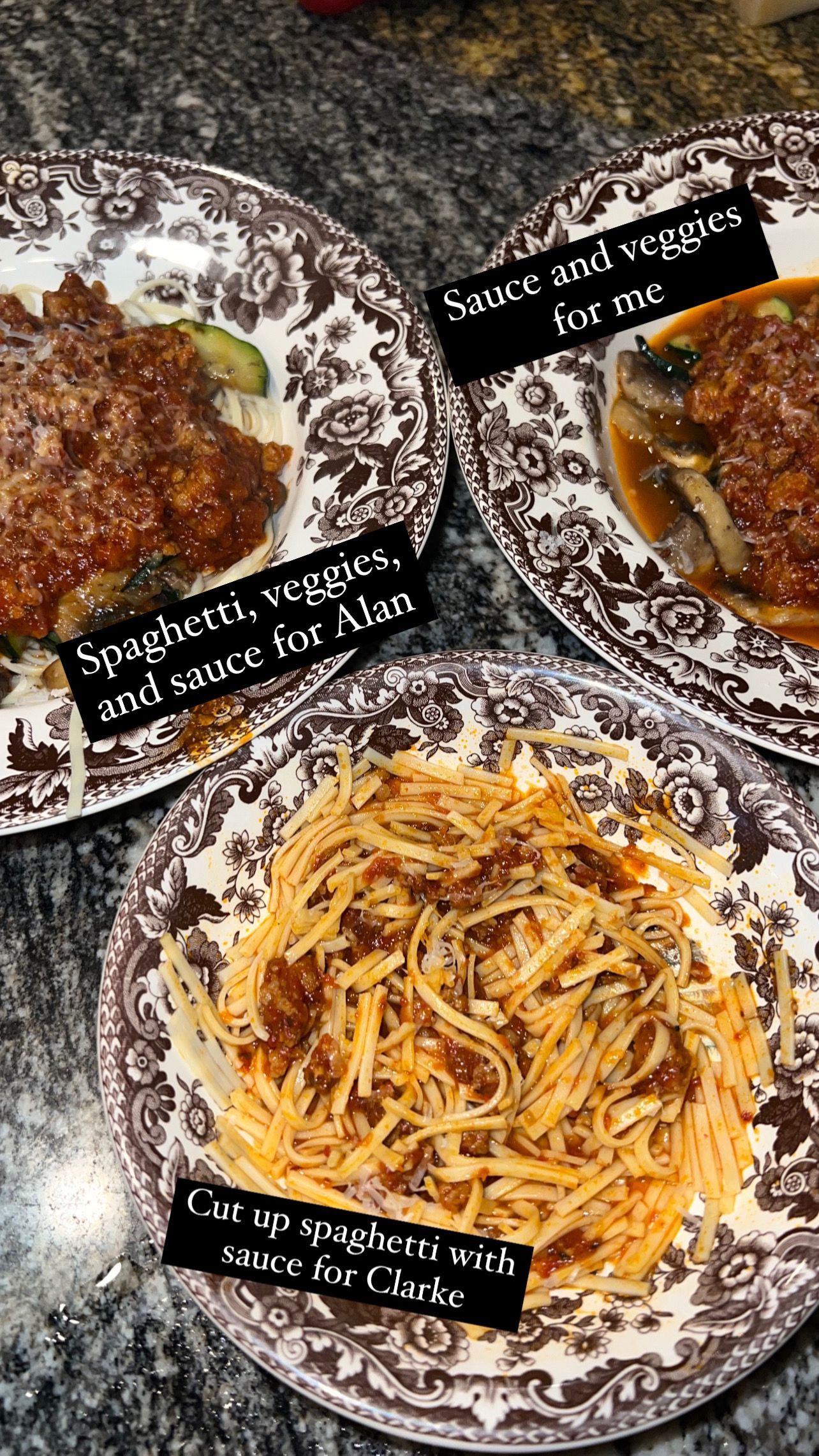 Three plated pasta dishes with black label tags on a patterned tablecloth.