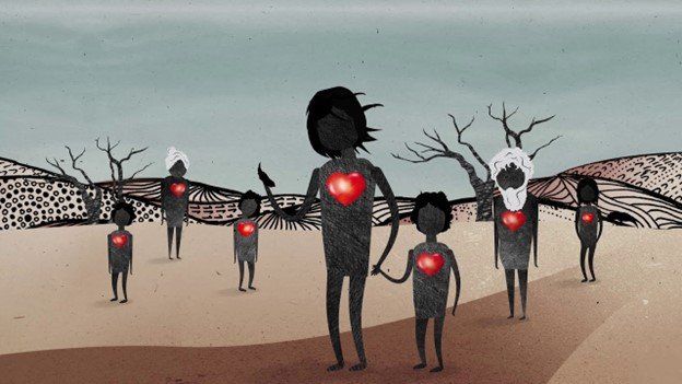 A group of people standing next to each other with hearts on their chests.