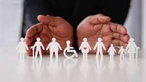 A person is holding a row of paper people in their hands.