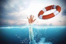 A person is drowning in the ocean and a life preserver is floating in the water.