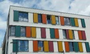 A building with a lot of windows and shutters on it.
