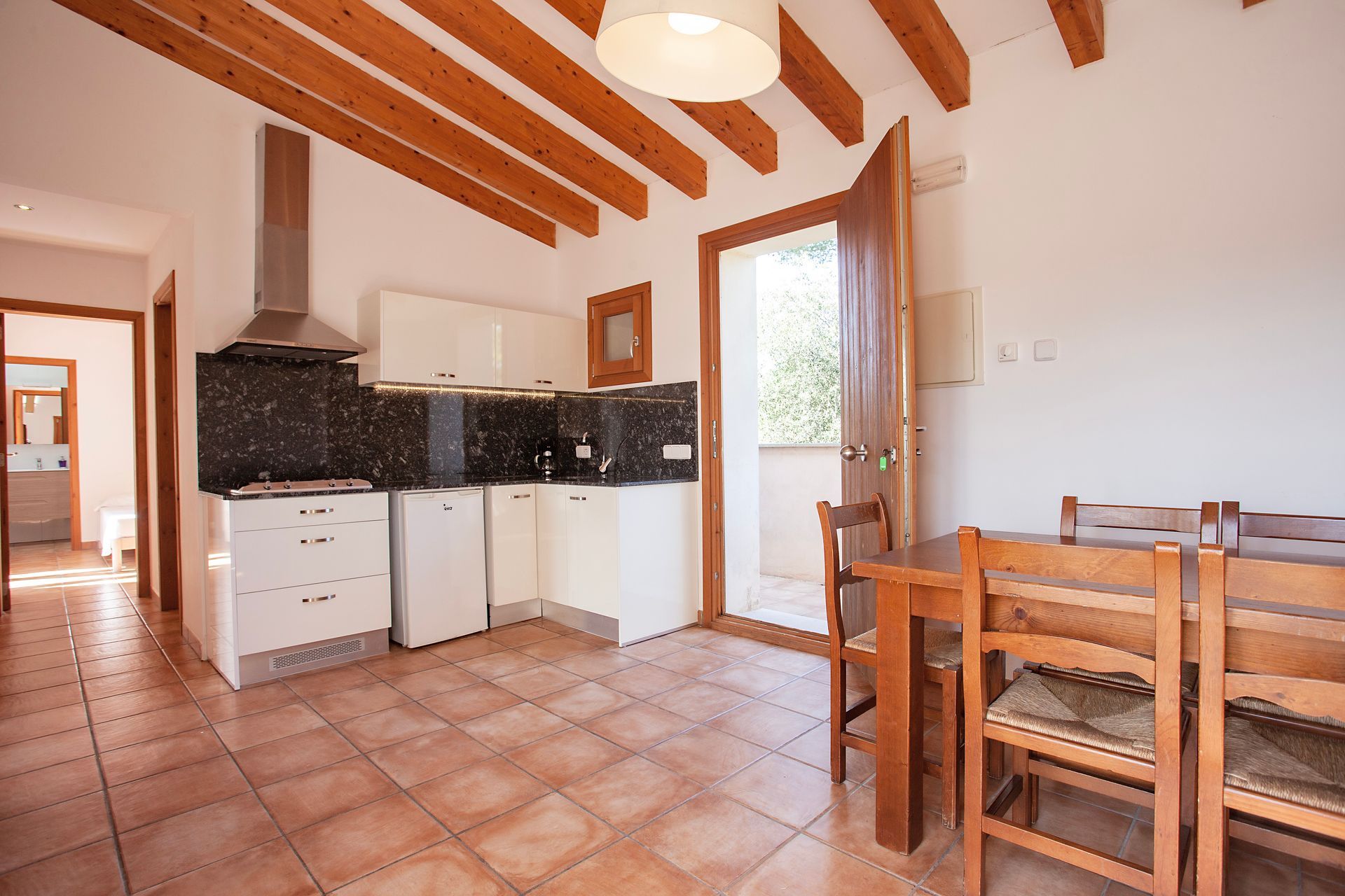 A kitchen with a table and chairs in it