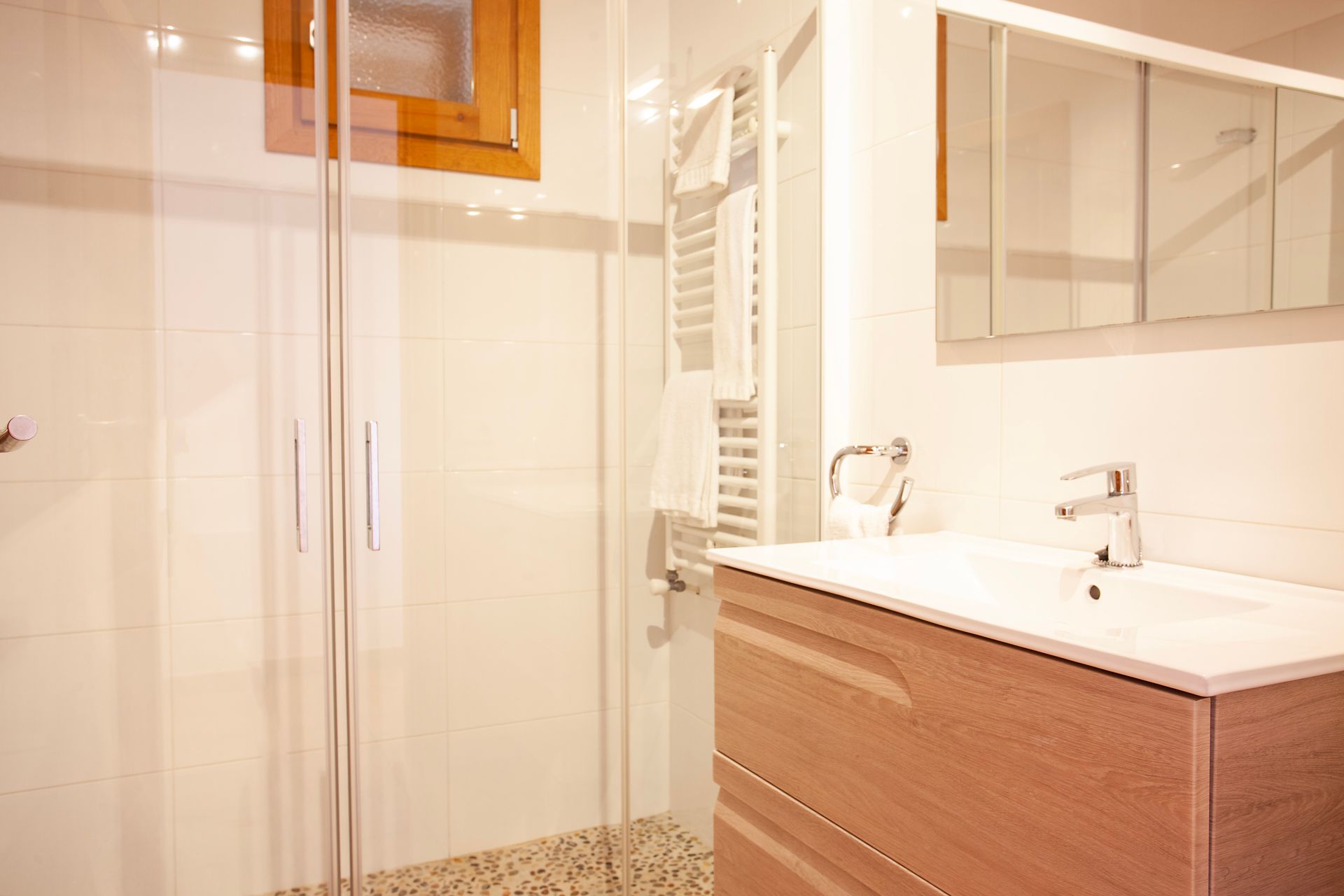 A bathroom with a sink and a walk in shower.