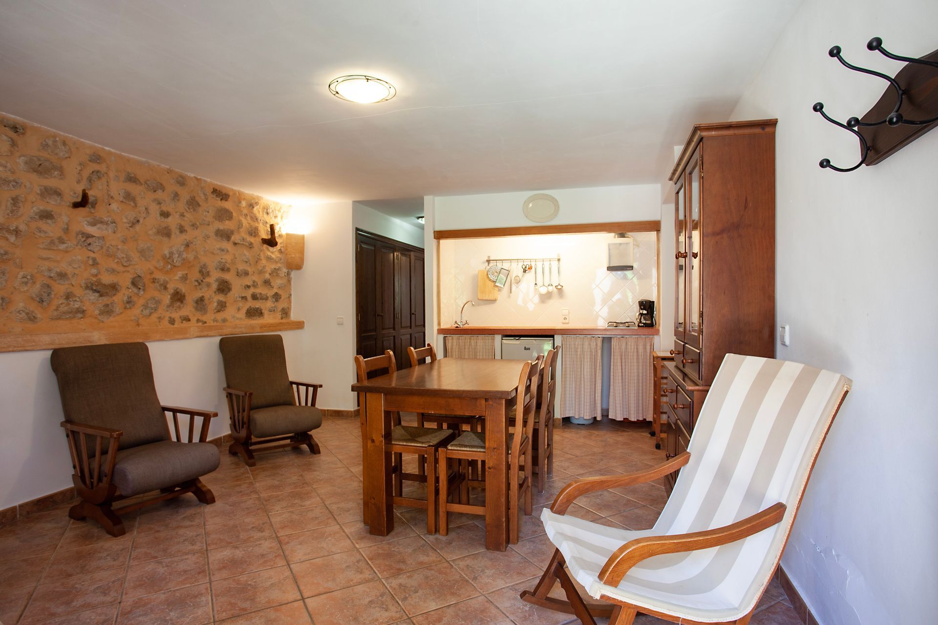 A living room with a table and chairs in it