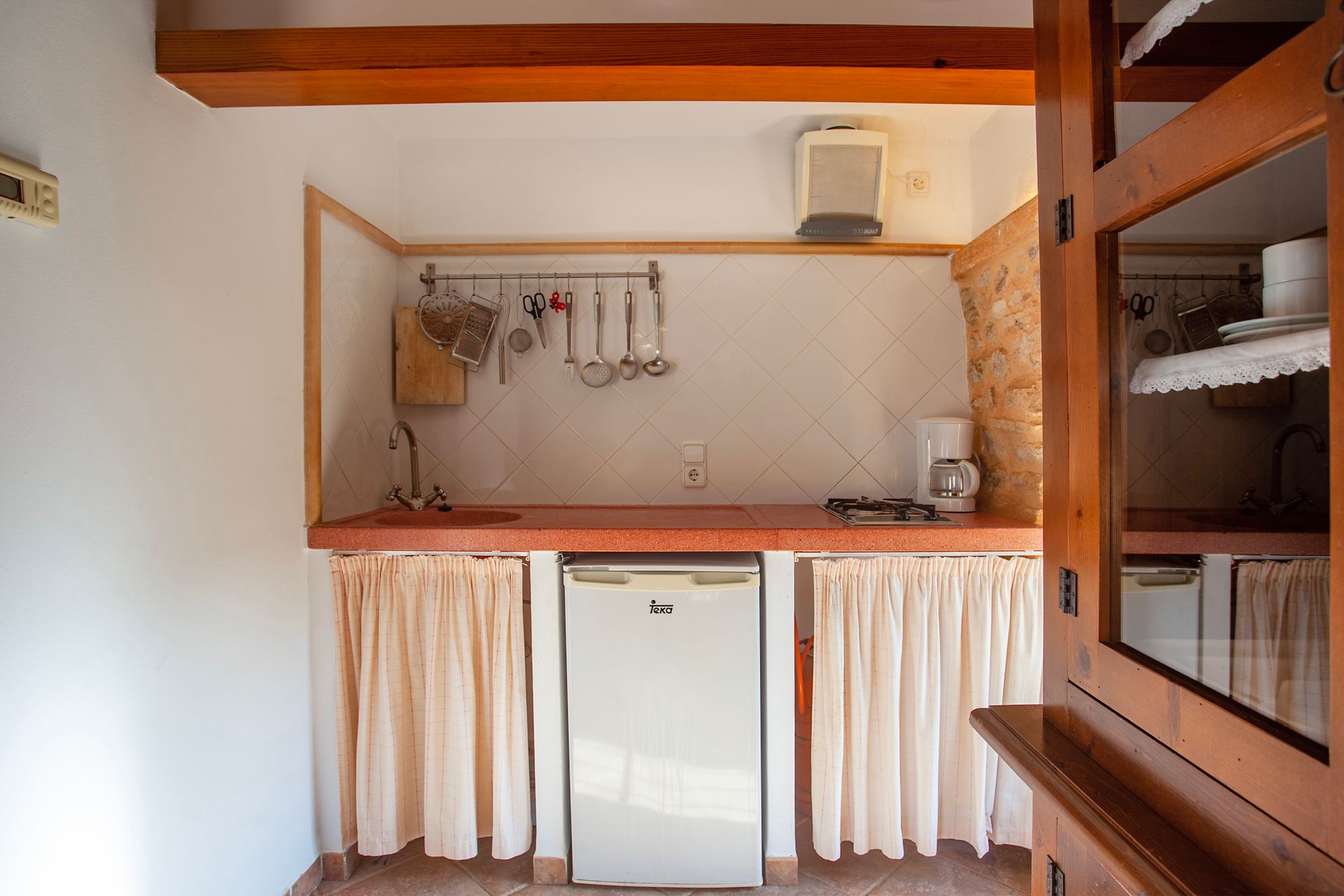 A small kitchen with a refrigerator and a sink
