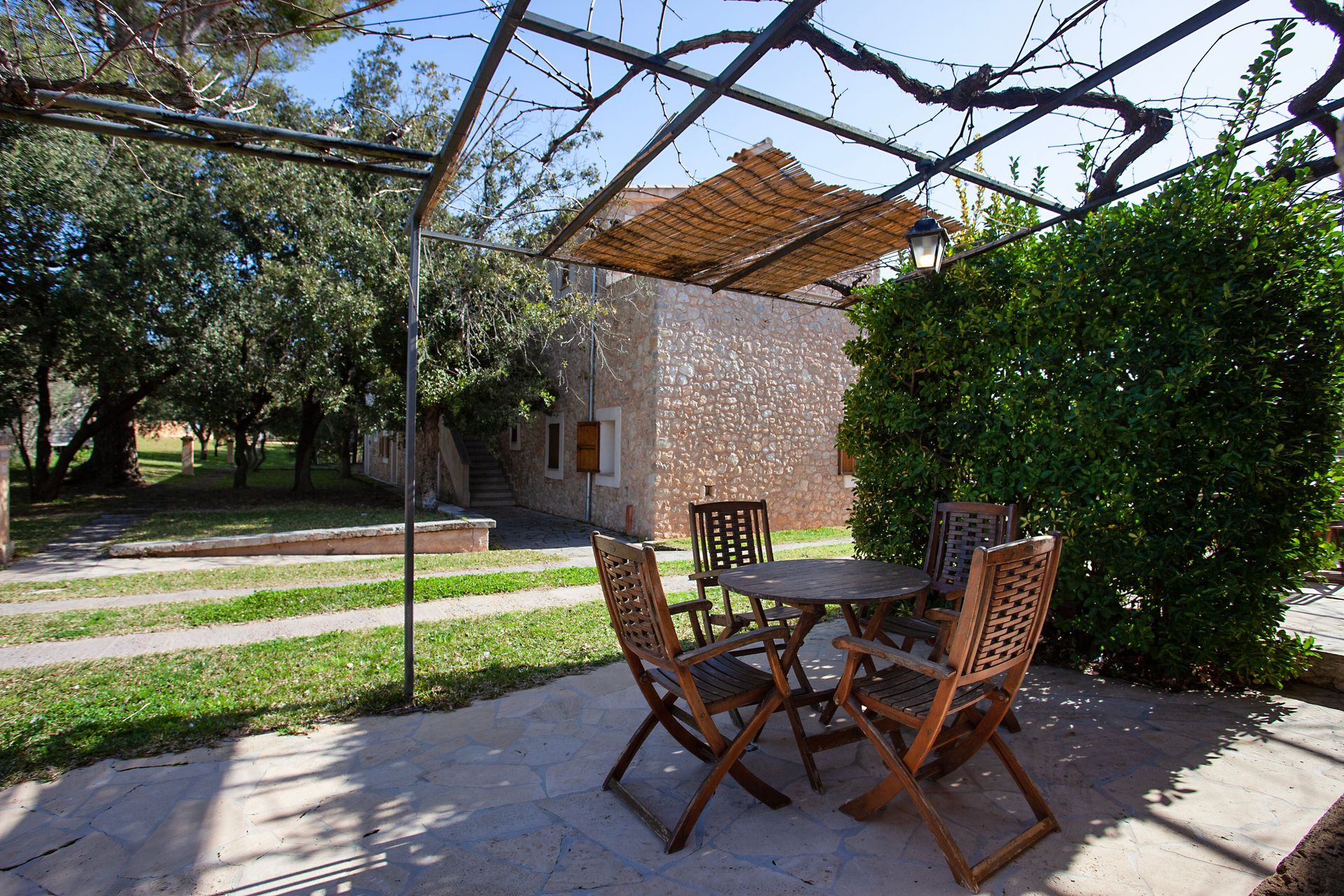 A patio with a table and chairs under a pergola