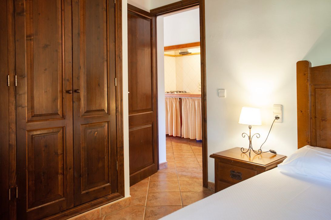 A bedroom with a bed , nightstand , and closet.