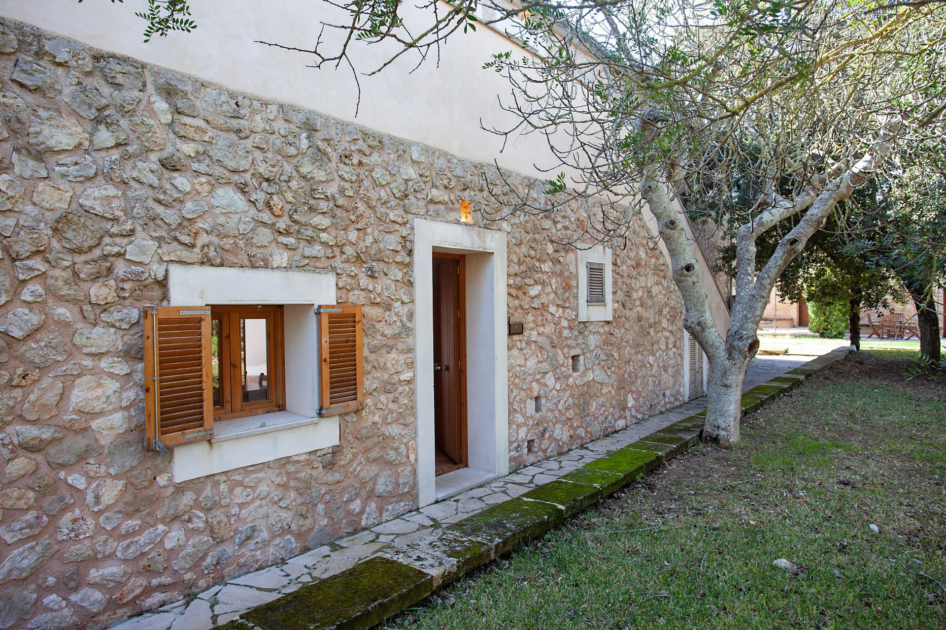 A stone building with a tree in front of it