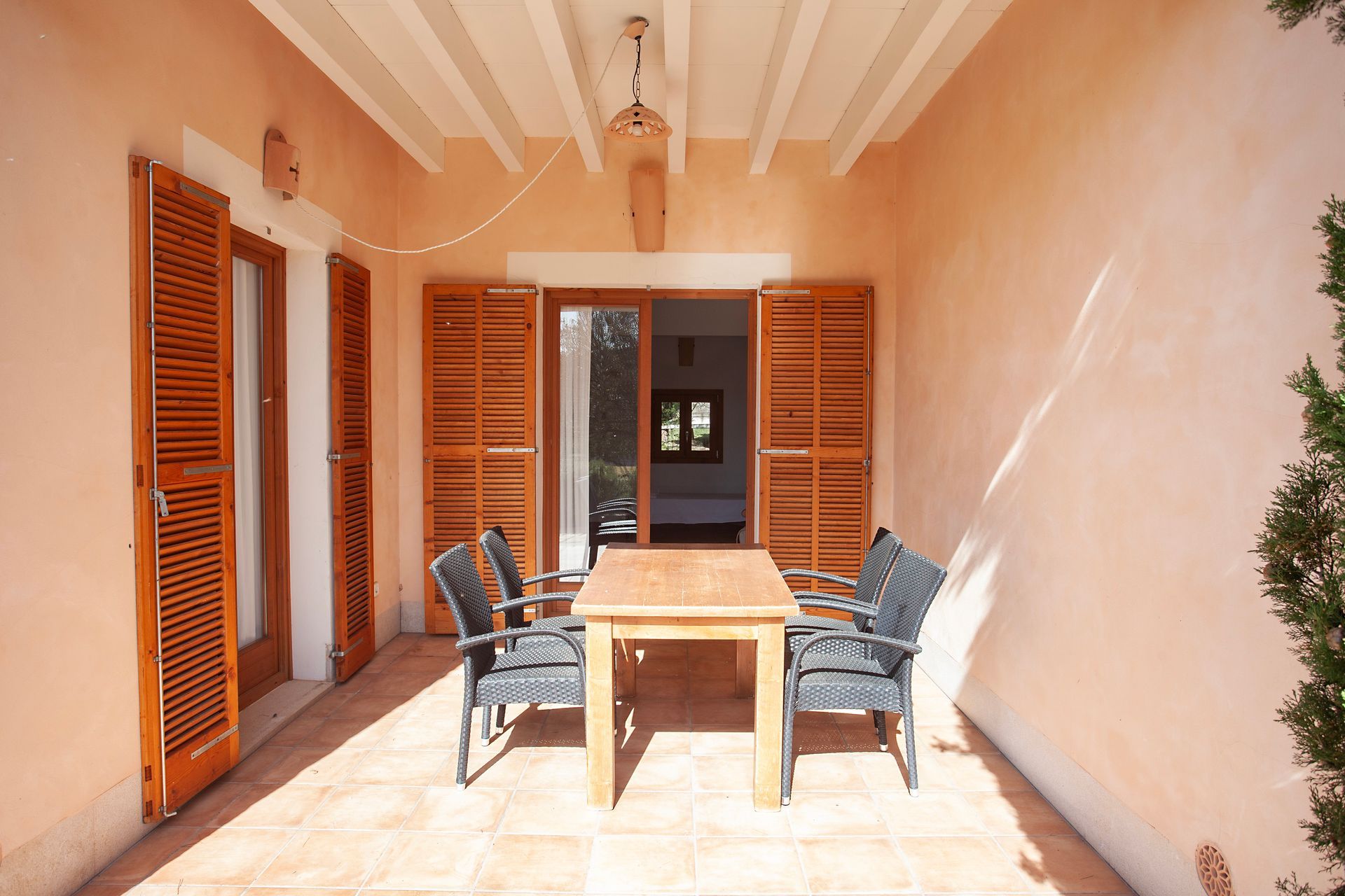 A patio with a table and chairs on it
