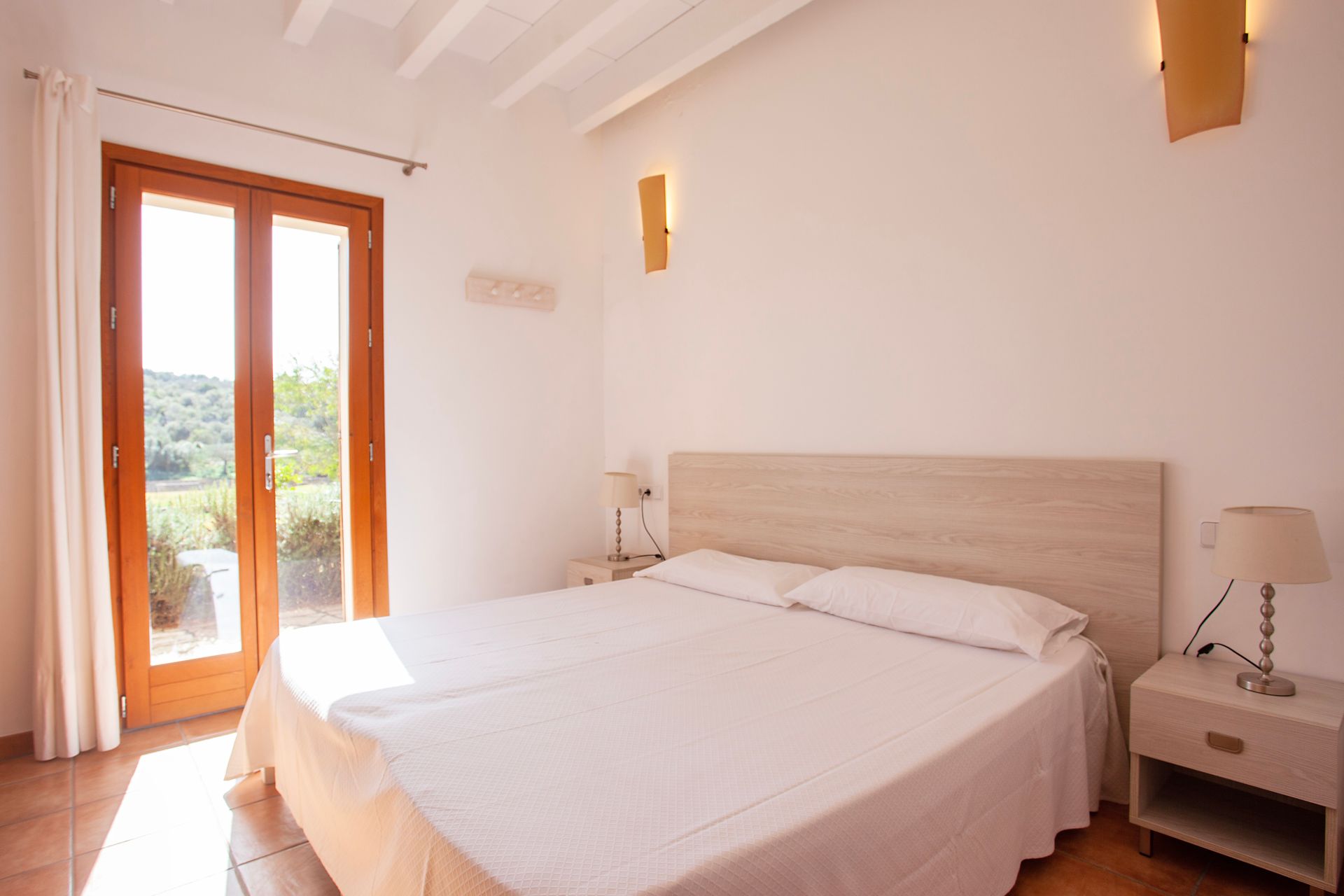 A bedroom with a large bed and a window