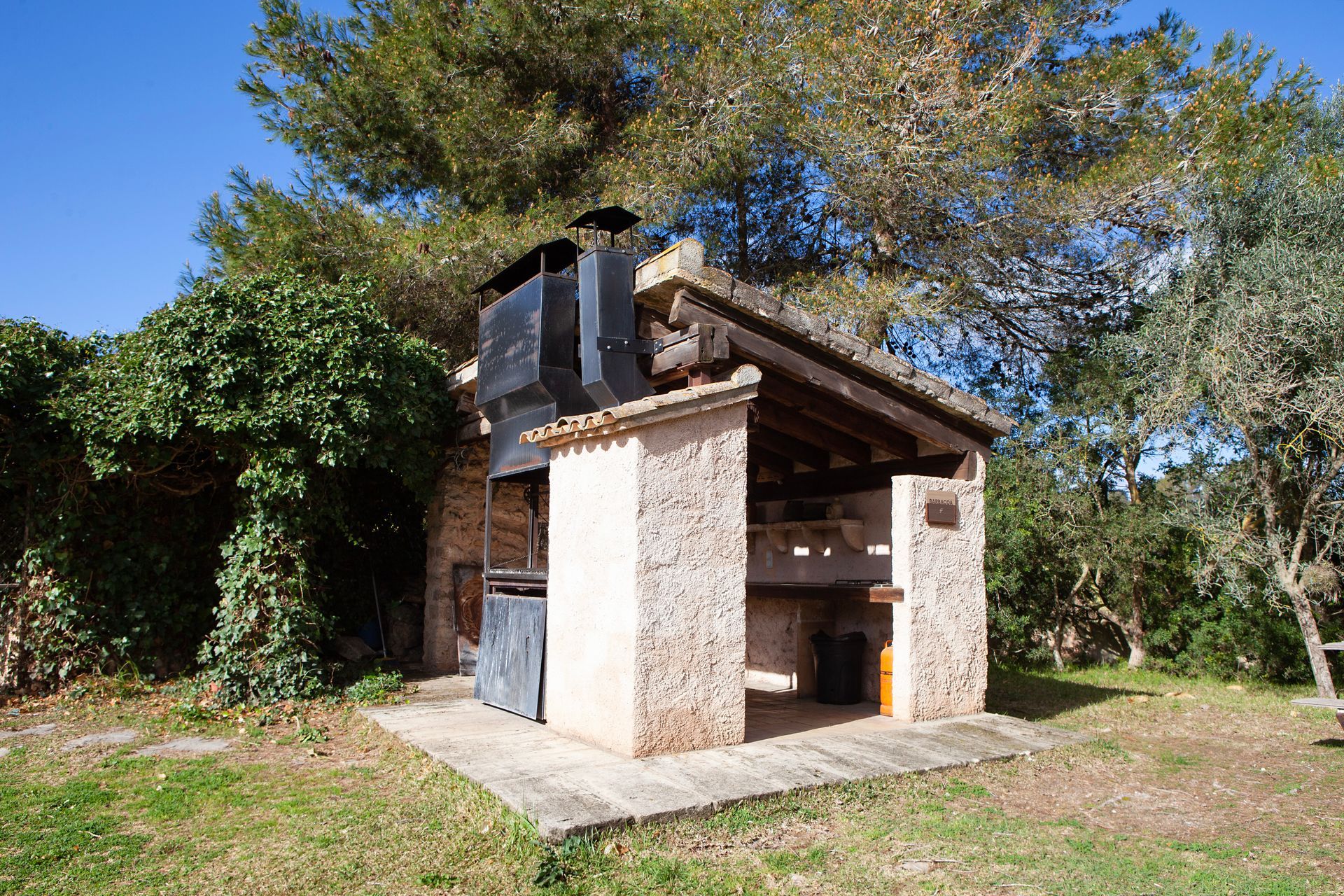 A small stone building with a chimney on top of it