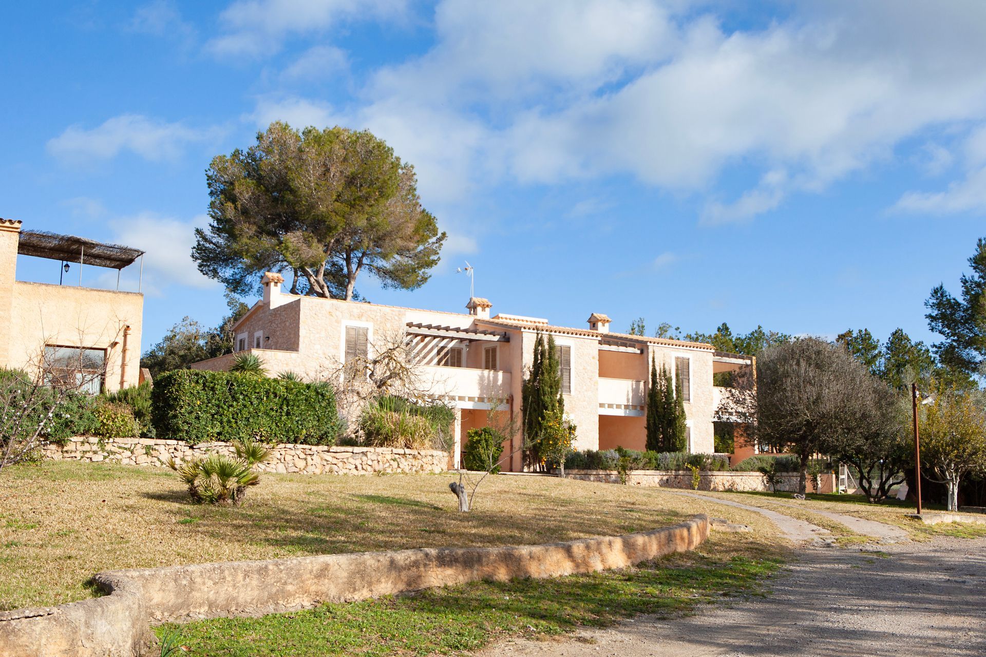 A large house with a lot of trees in front of it