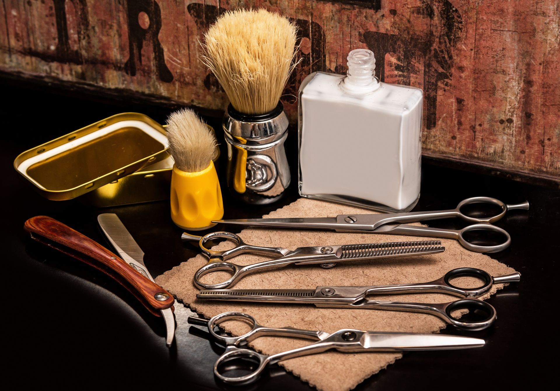 A shaving brush , scissors , and a bottle of shaving cream are on a table.