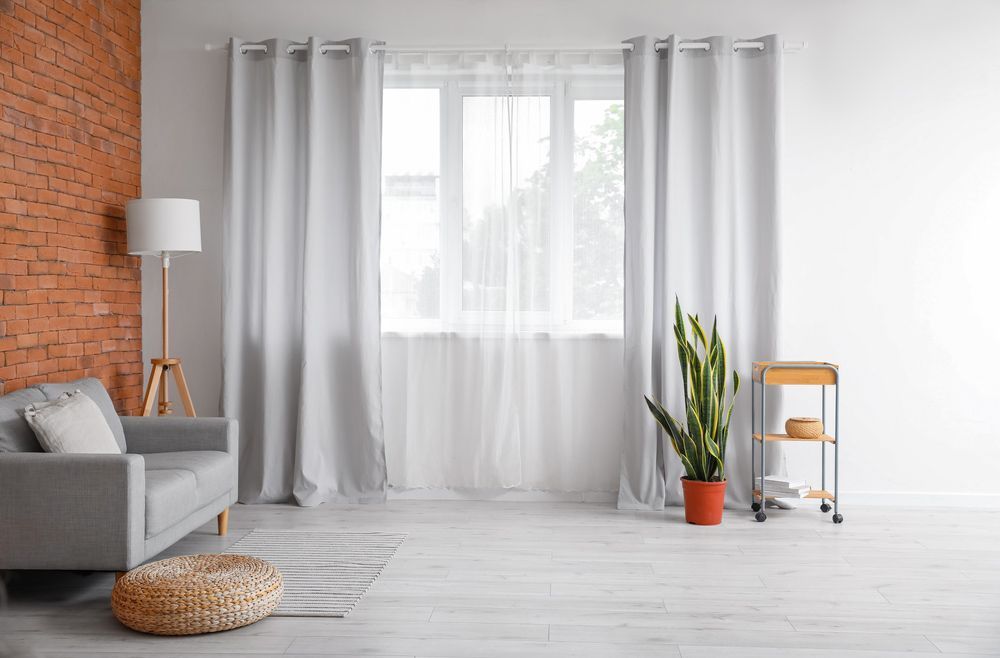 Inviting Living Room with White Curtains, a Comfortable Couch, and a Potted Plant — Curtains in Gold Coast, QLD