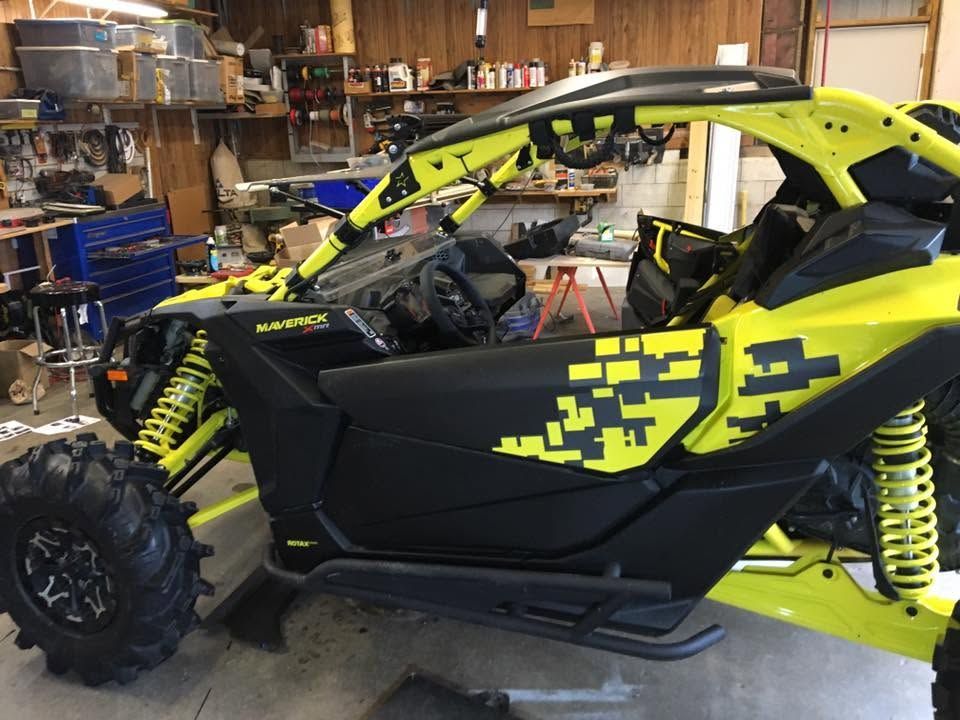 Yellow and black off-road dune buggy in a garage, side view with exposed suspension