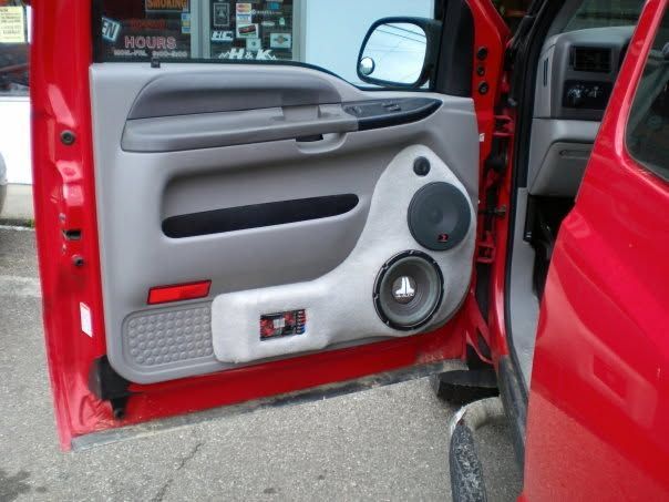 Custom red car door with gray speaker panels and open interior view
