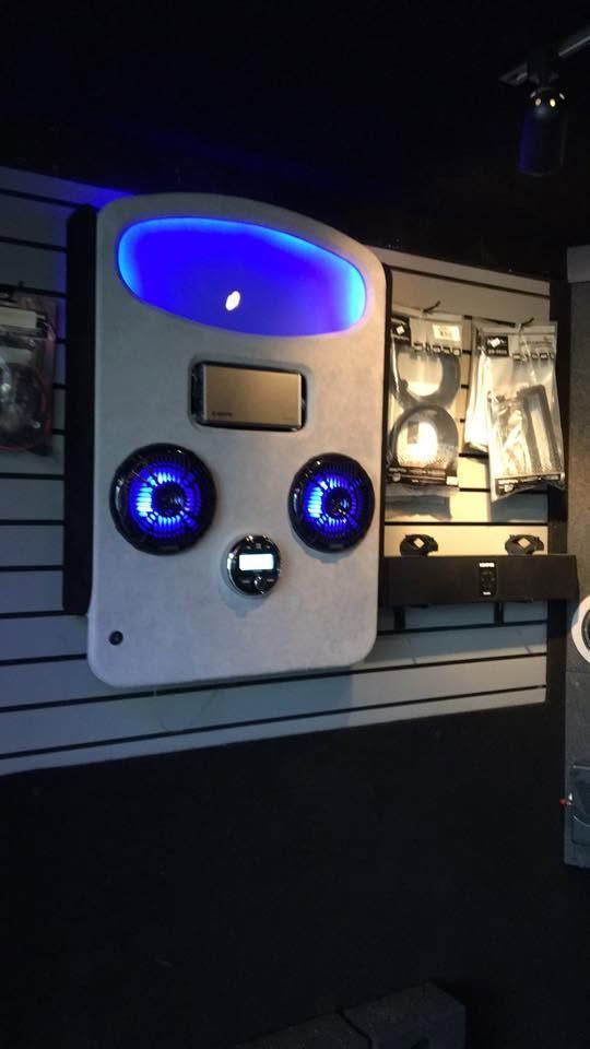 Illuminated arcade machine with blue lights in a dark indoor setting