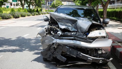 Front view of a crashed car on a street.
