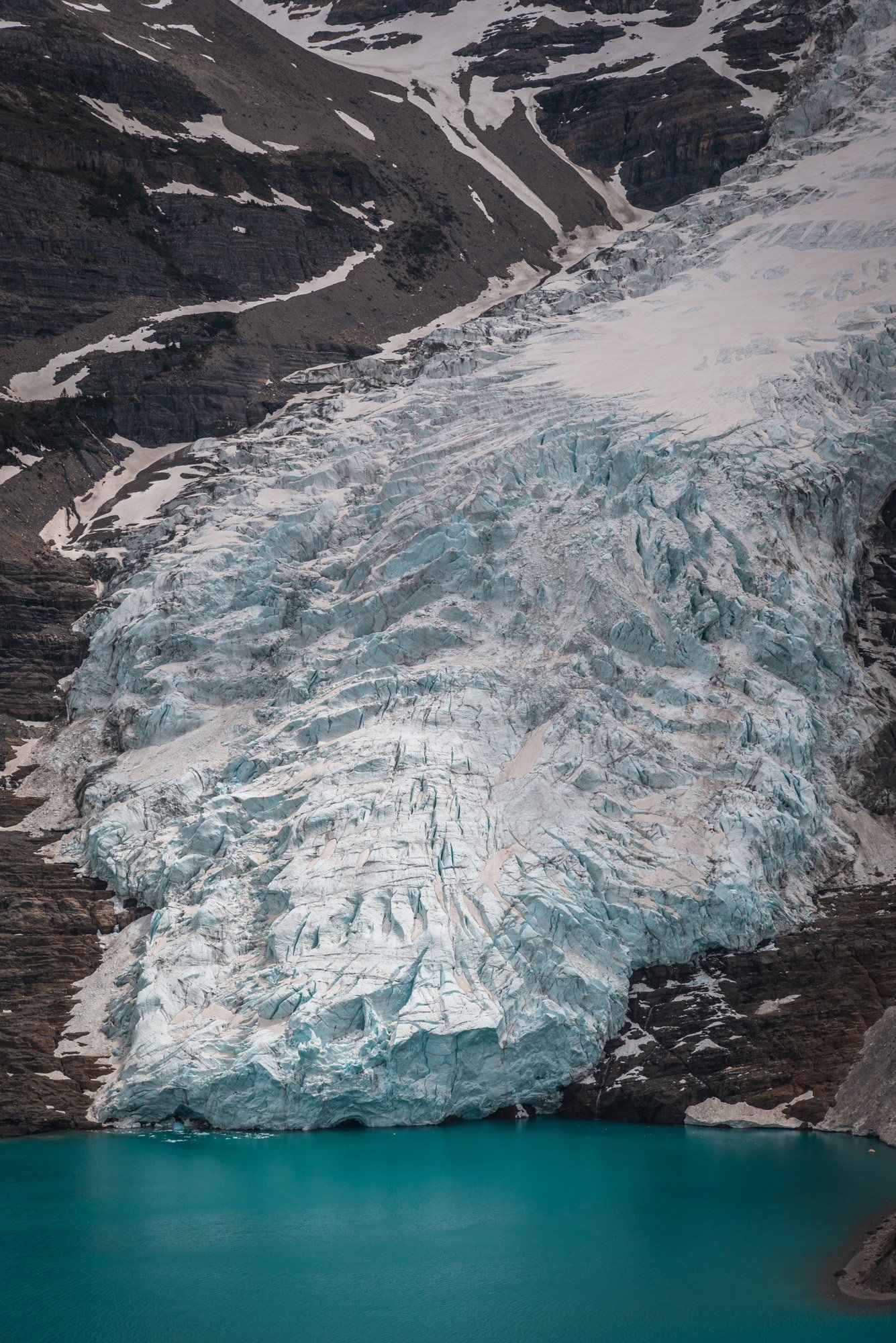 Berg glacier, mt Robson park, BC, Canada. Turquoise lake and mountains touched with first rays of morning sun