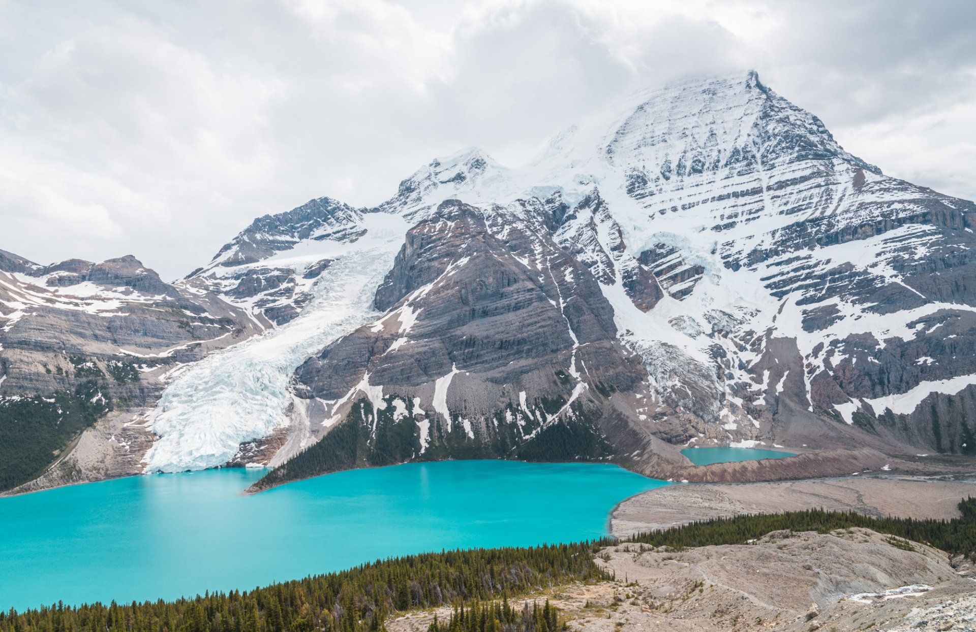 View from Hargreaves lake trail, mt Robson park, BC, Canada. Turquoise lake and mountains touched with first rays of morning sun