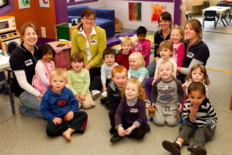 A group of children are posing for a picture in a classroom
