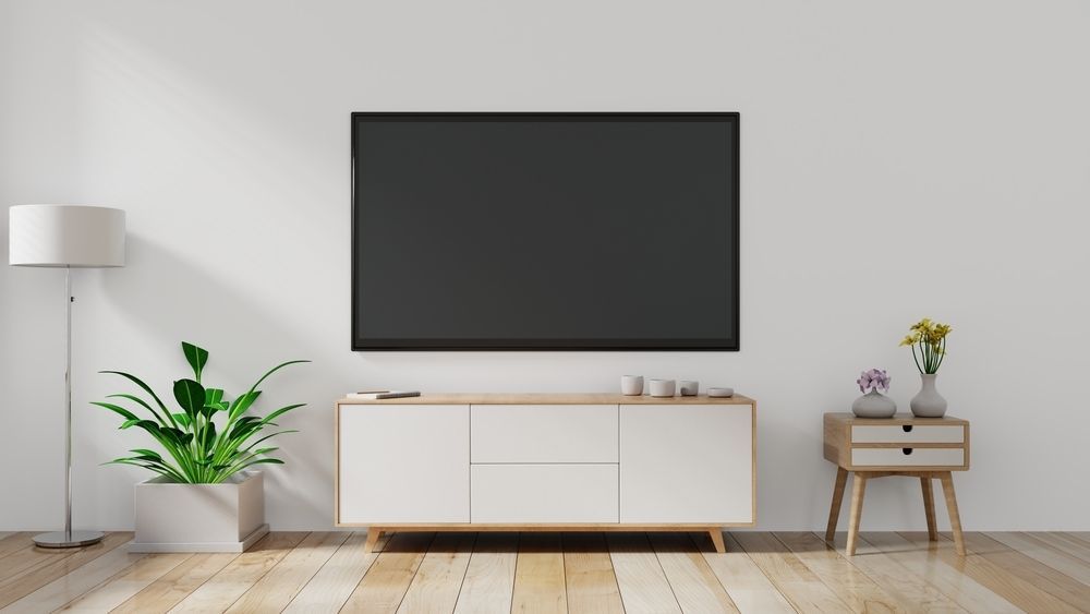 A Living Room With a Flat Screen Tv on the Wall — Anton's New & Used Furniture In Ciccone, NT