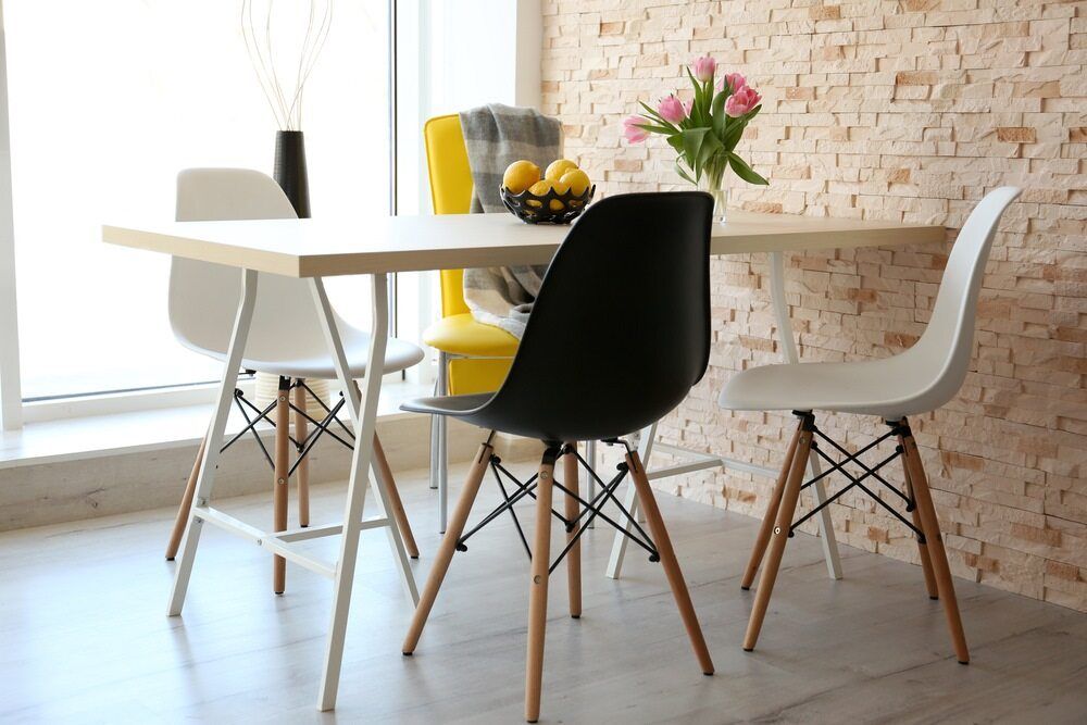 A Dining Room Table and Chairs in Front of a Brick Wall — Anton's New & Used Furniture In Ciccone, NT