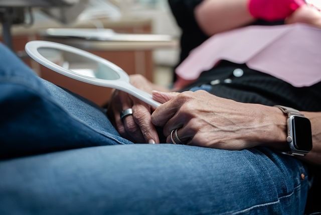Close-up of hands holding a tennis racket on jeans