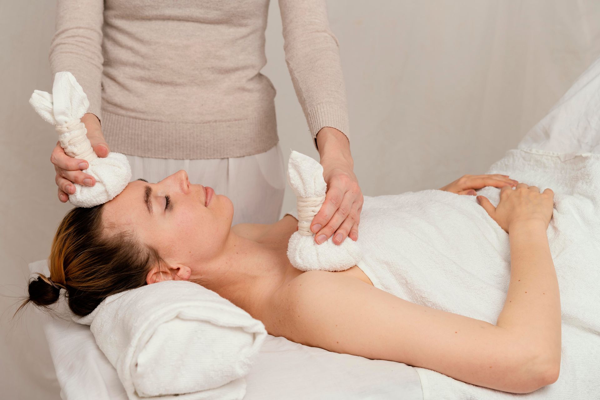 A skincare specialist using cooling globes to gently massage and soothe the skin, reducing puffiness and enhancing relaxation during a facial treatment
