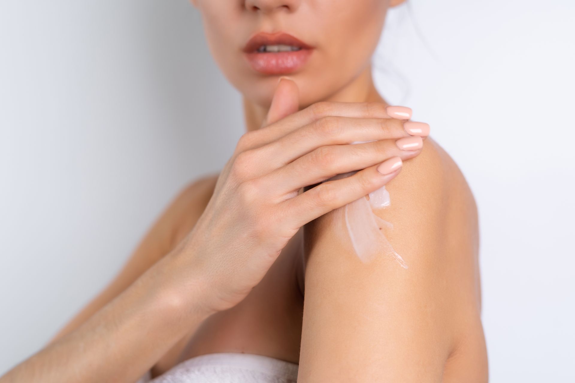 A skincare specialist carefully applying exfoliation lotion during a rejuvenating facial treatment