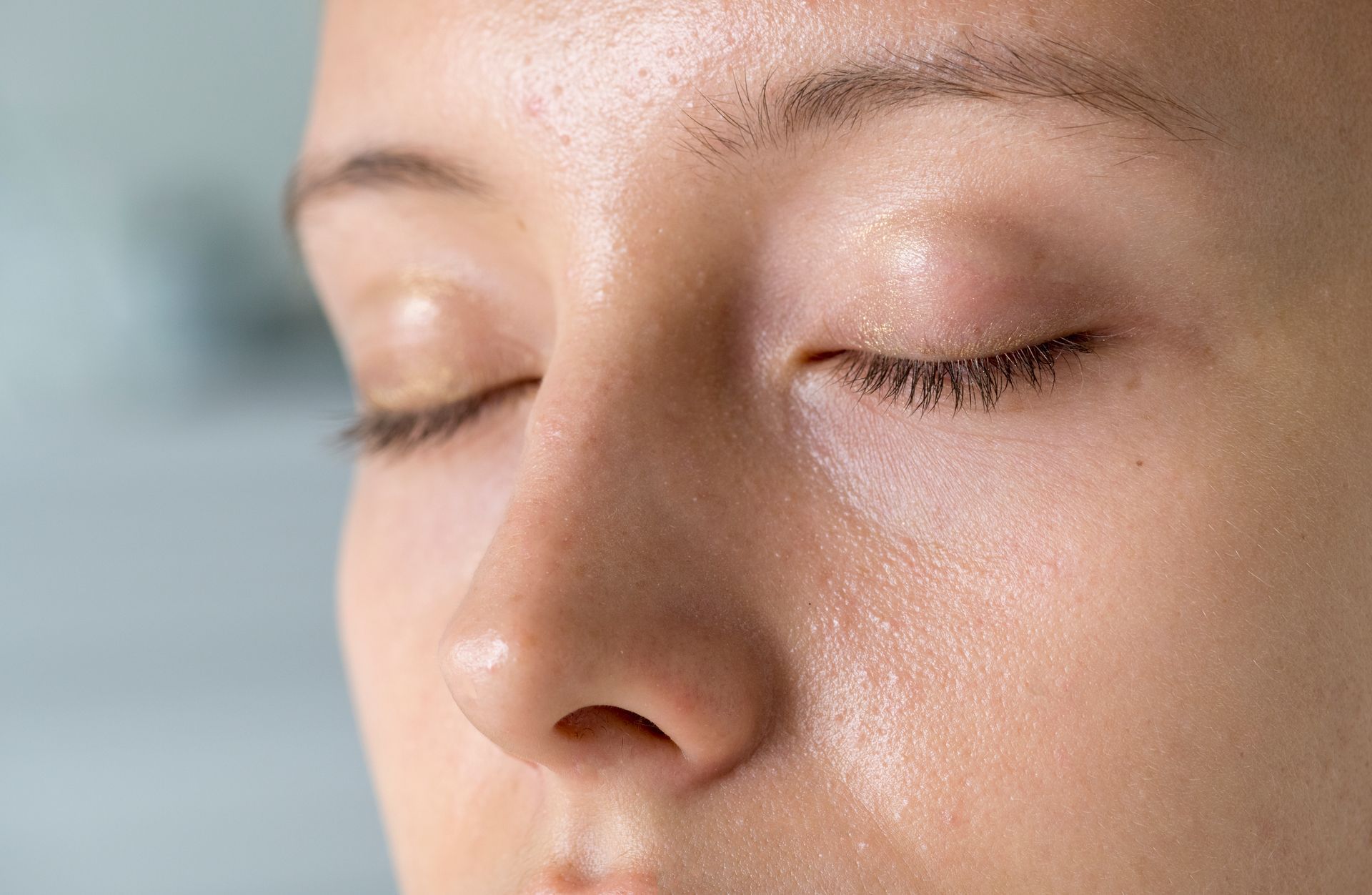 A skincare specialist applying a revitalizing mask or serum to rejuvenate and brighten dull skin during a professional facial treatment