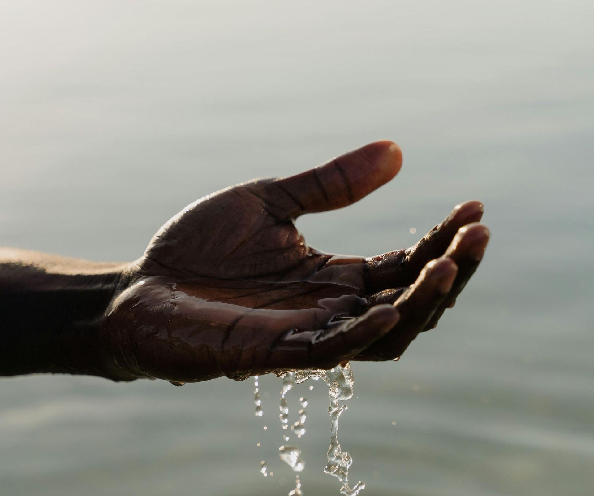 Water flowing through hands, symbolizing deep hydration and skin nourishment.