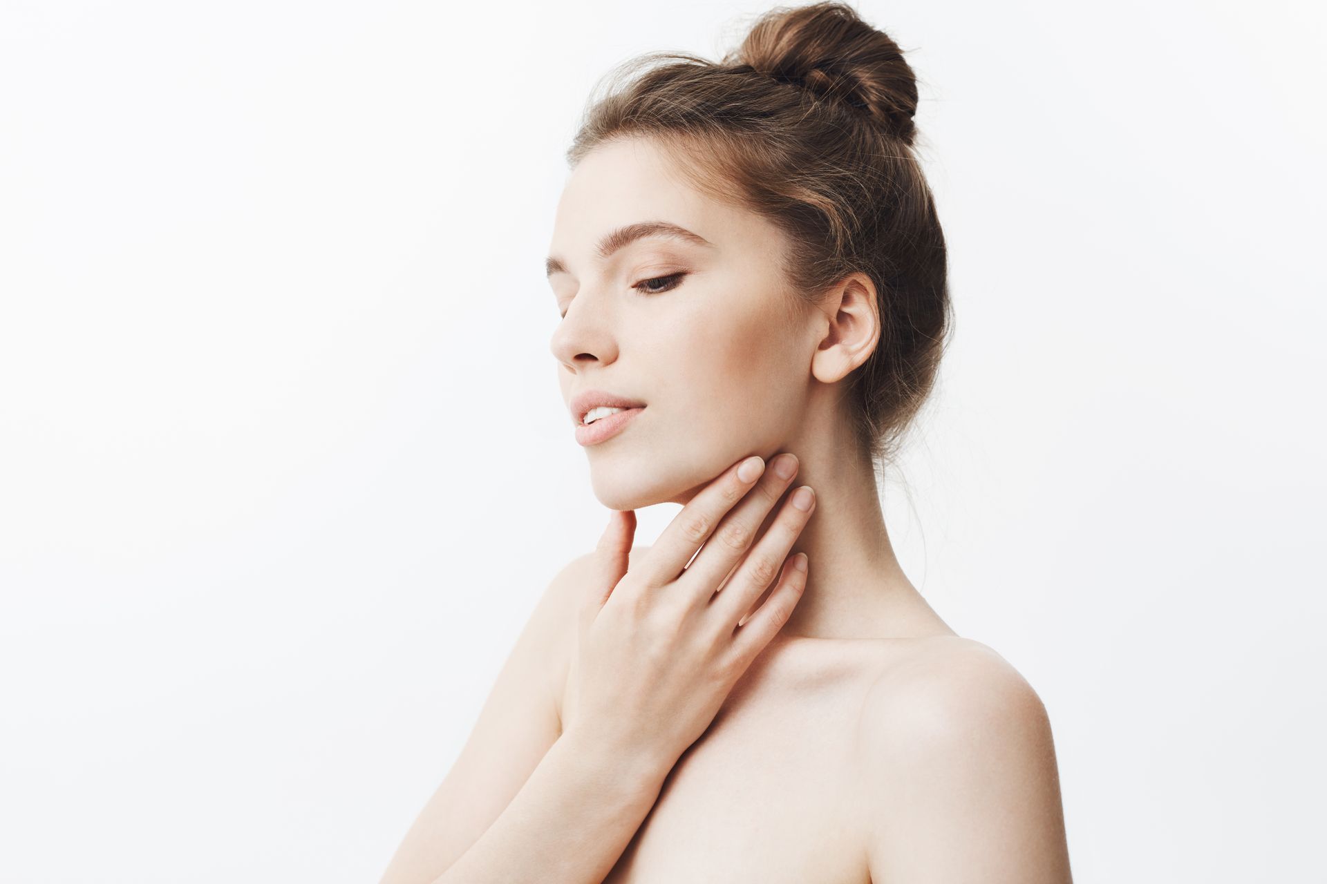 A skincare specialist using a firming treatment or device to restore elasticity and tighten the skin during a professional facial session