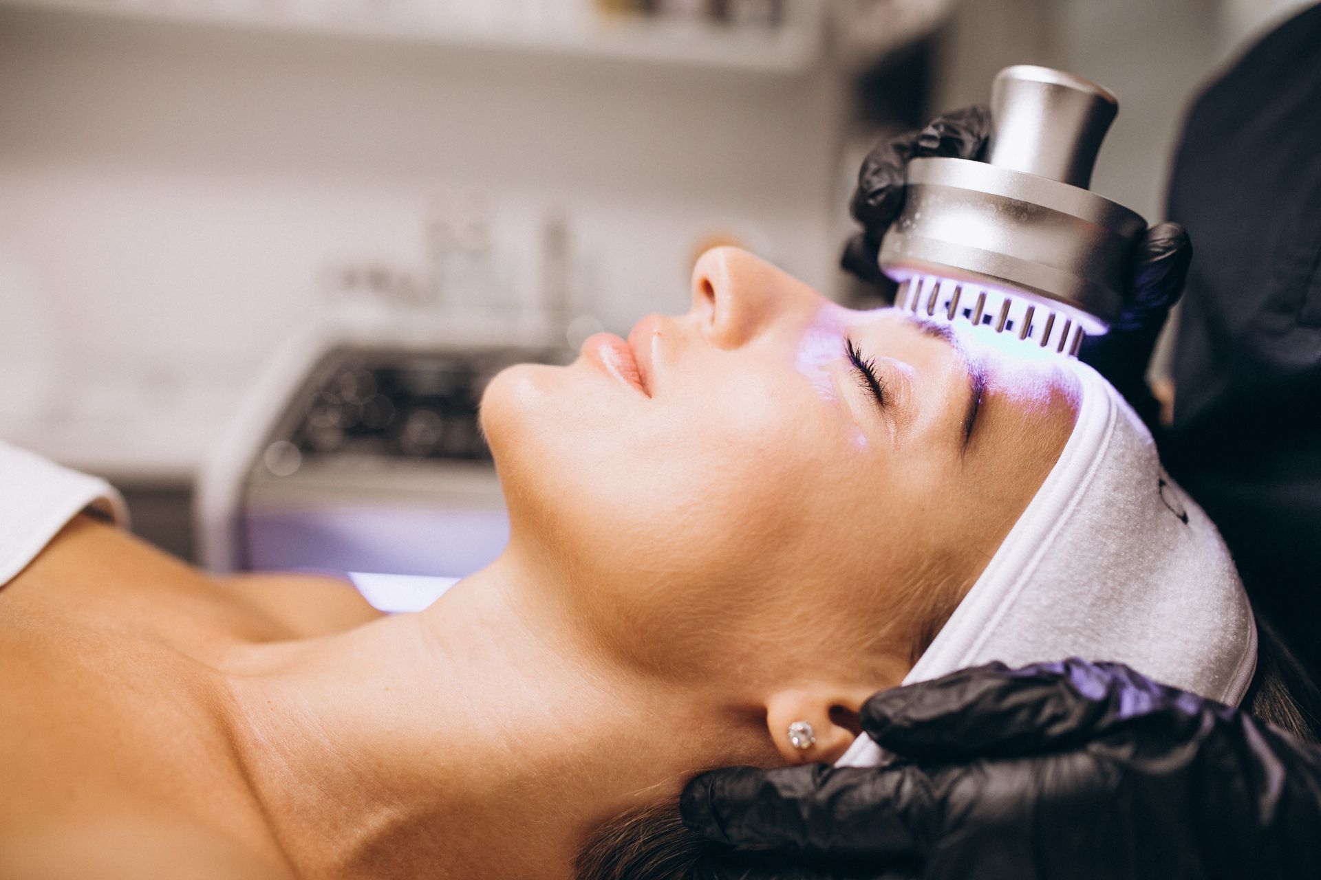 LED light therapy being applied to a client’s face for skin rejuvenation and healing.
