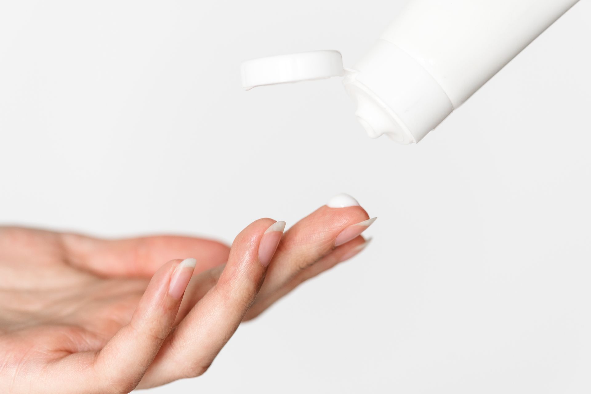 A skincare specialist applying the final touches, gently smoothing to complete a facial session.