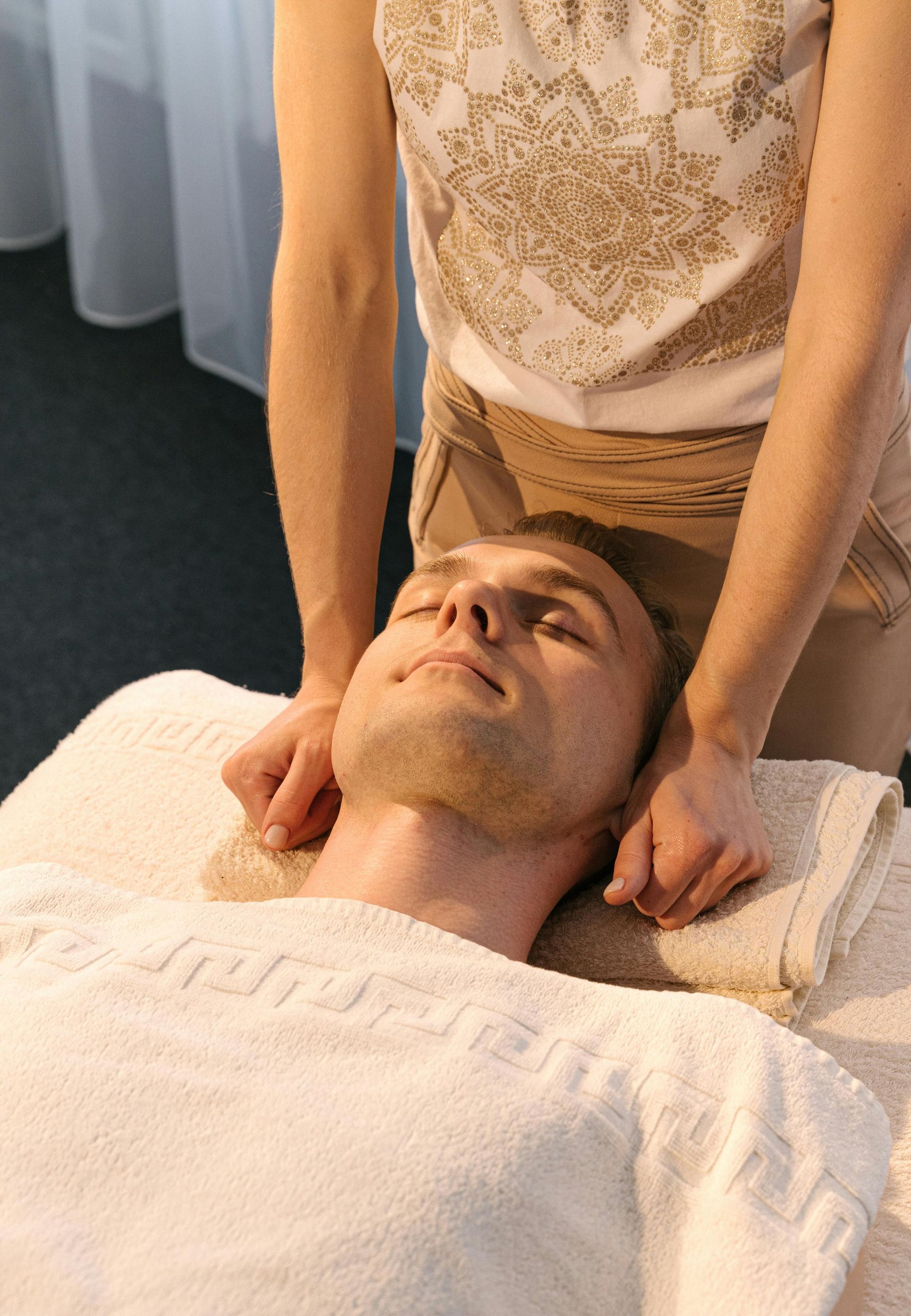 Professional esthetician performing a relaxing facial massage to relieve tension and improve circulation.
