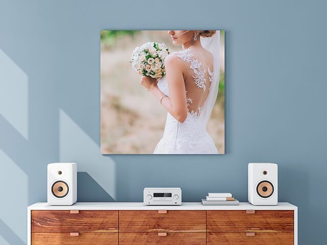 A bride in a wedding dress is holding a bouquet of flowers.