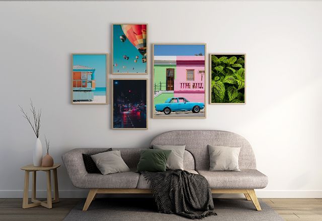 A living room with a couch and a collage of pictures on the wall.